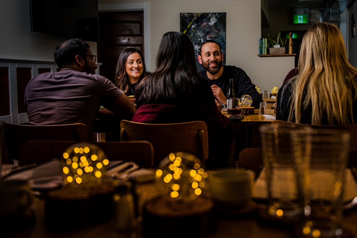 smiling faces at a cozy dinner date at 1909 culinary academy