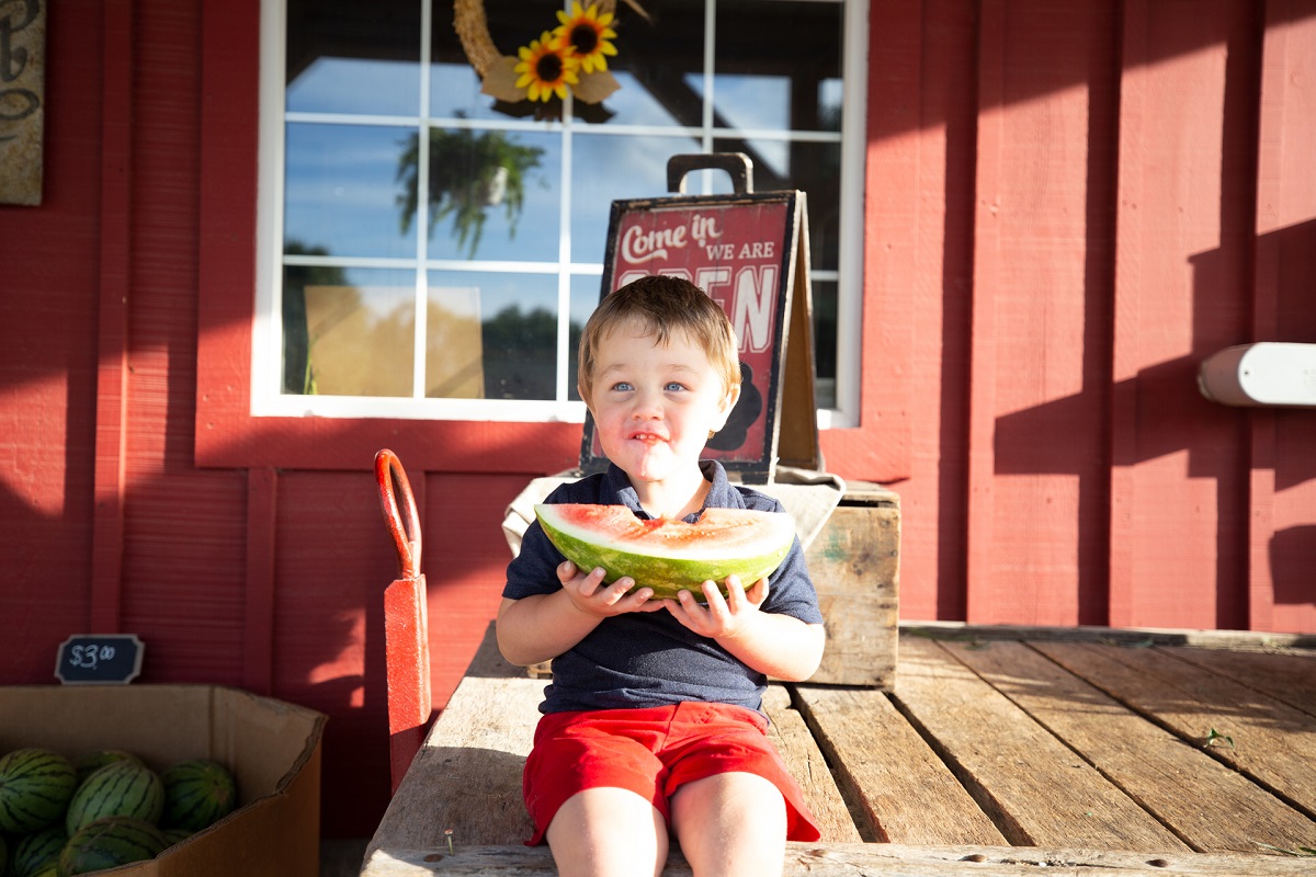 child eating watermelon at bre