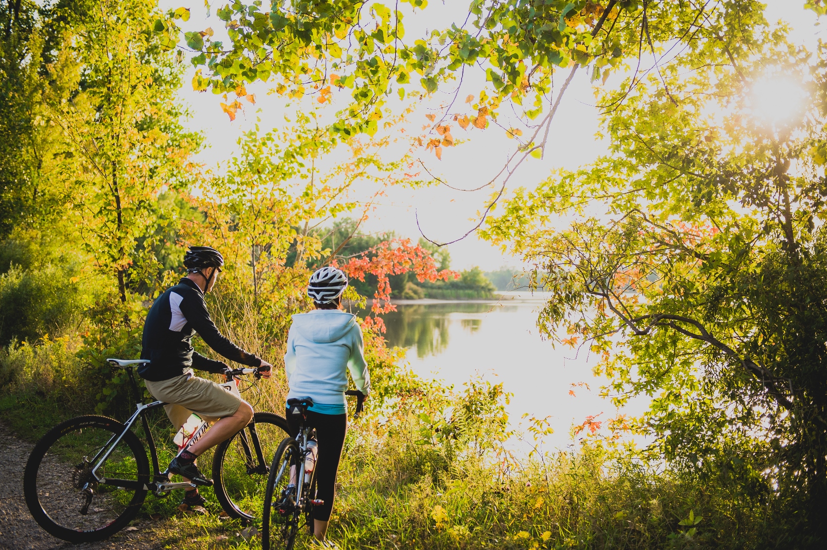 photo of a couple of riders looking out at the water on a trail ride