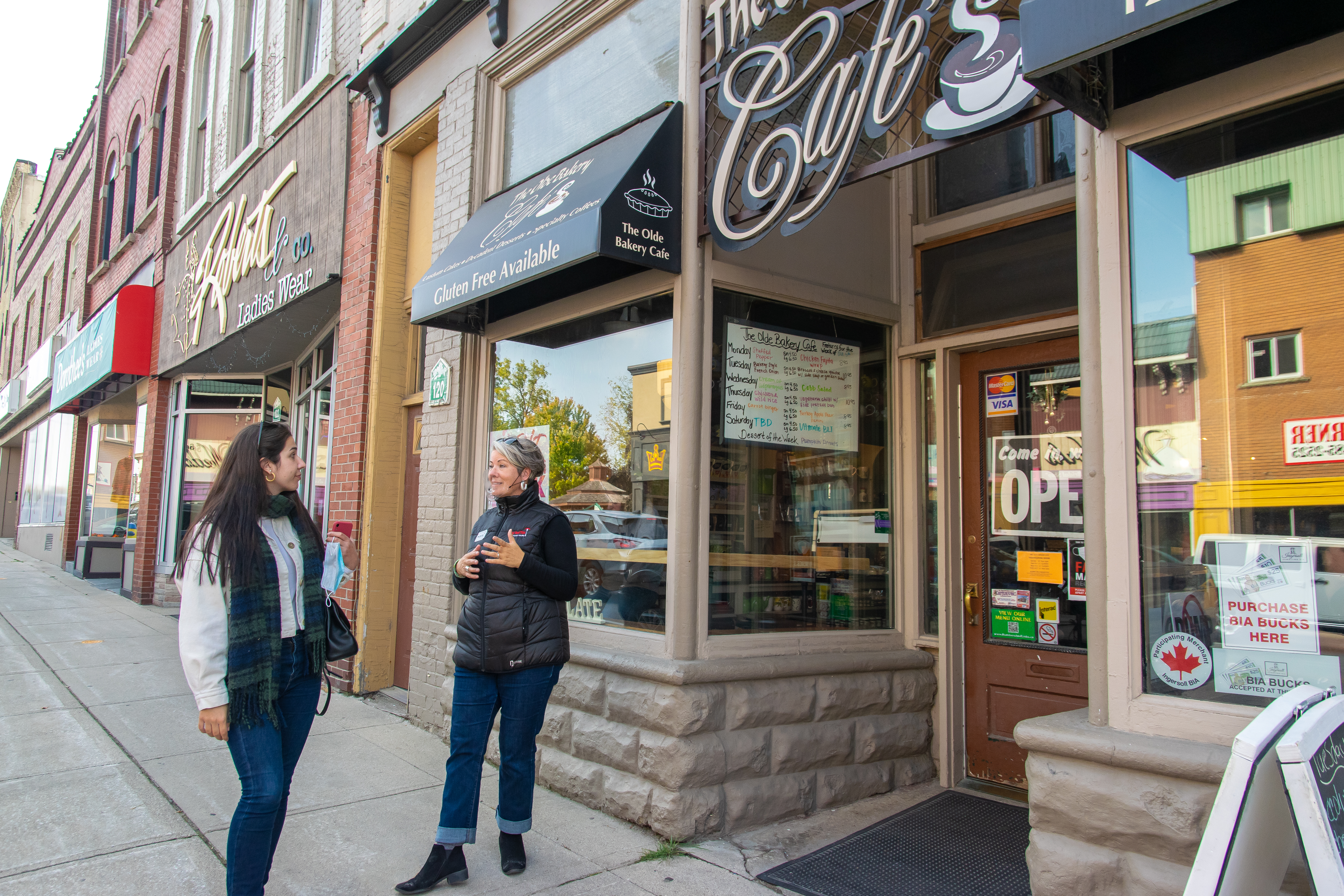 Two people outside The Olde Bakery Cafe