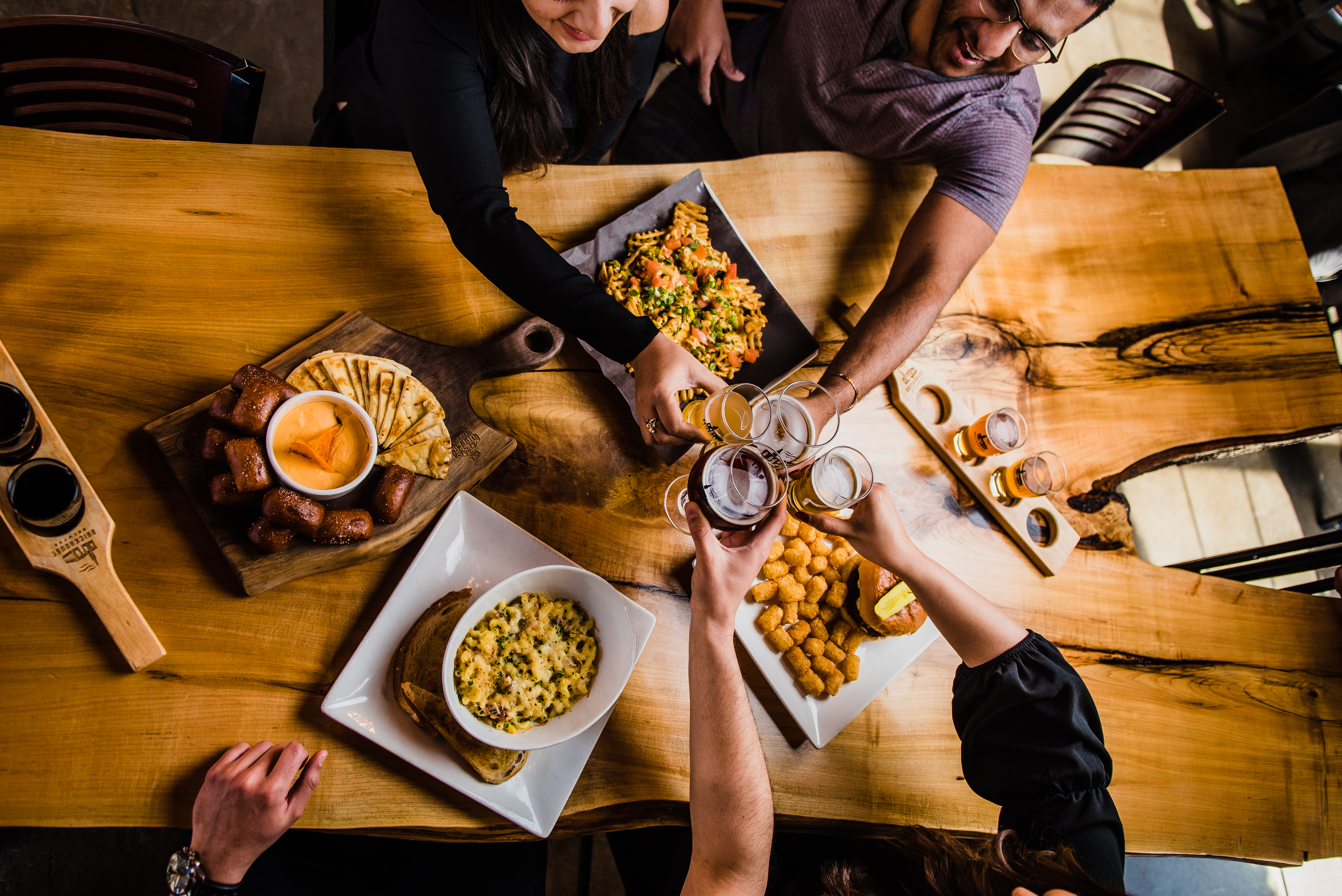 Group of 4 people toasting over a dinner table