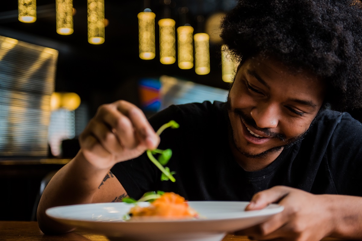 man adding a garnish to a dish at finkle street 