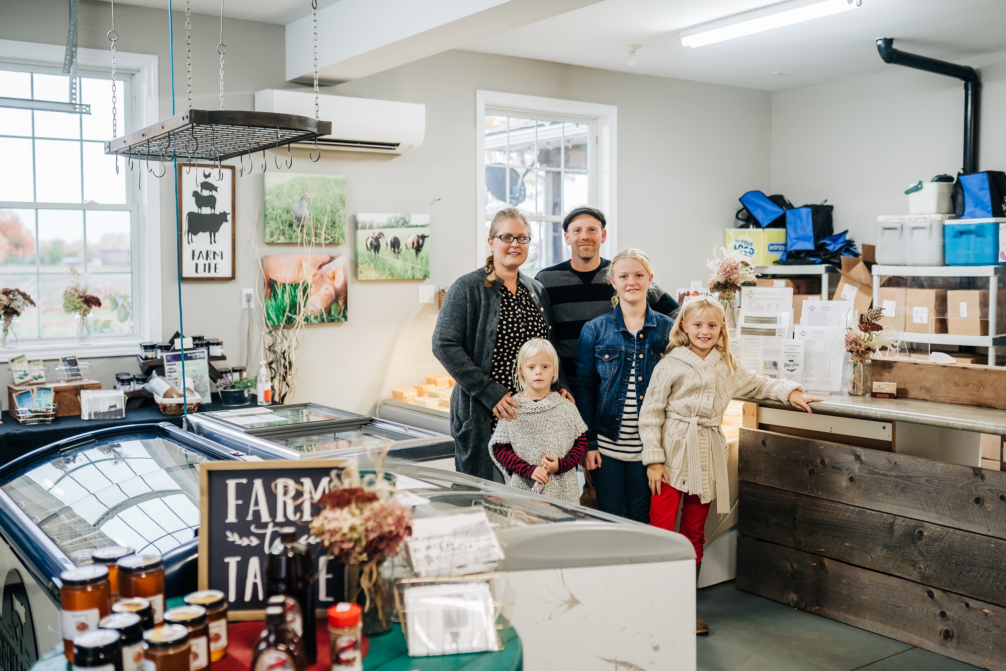 Carl and Andrea and kids inside farm store at greener pastures eco farm