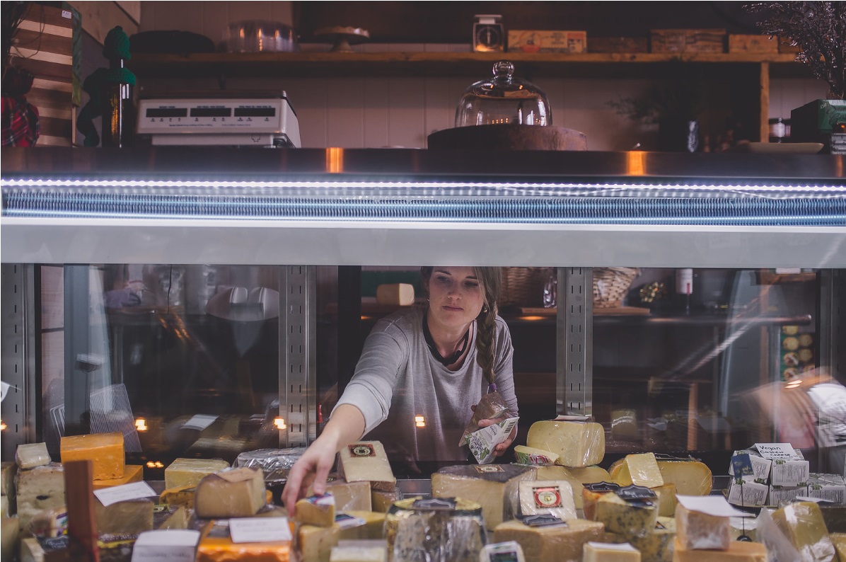 annelies in the cheese counter at the ingersoll wine cellar and cheese shop