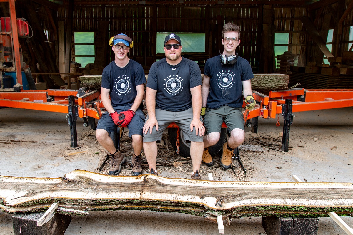 houston family at Kintore Custom Hardwoods in front of the plainer