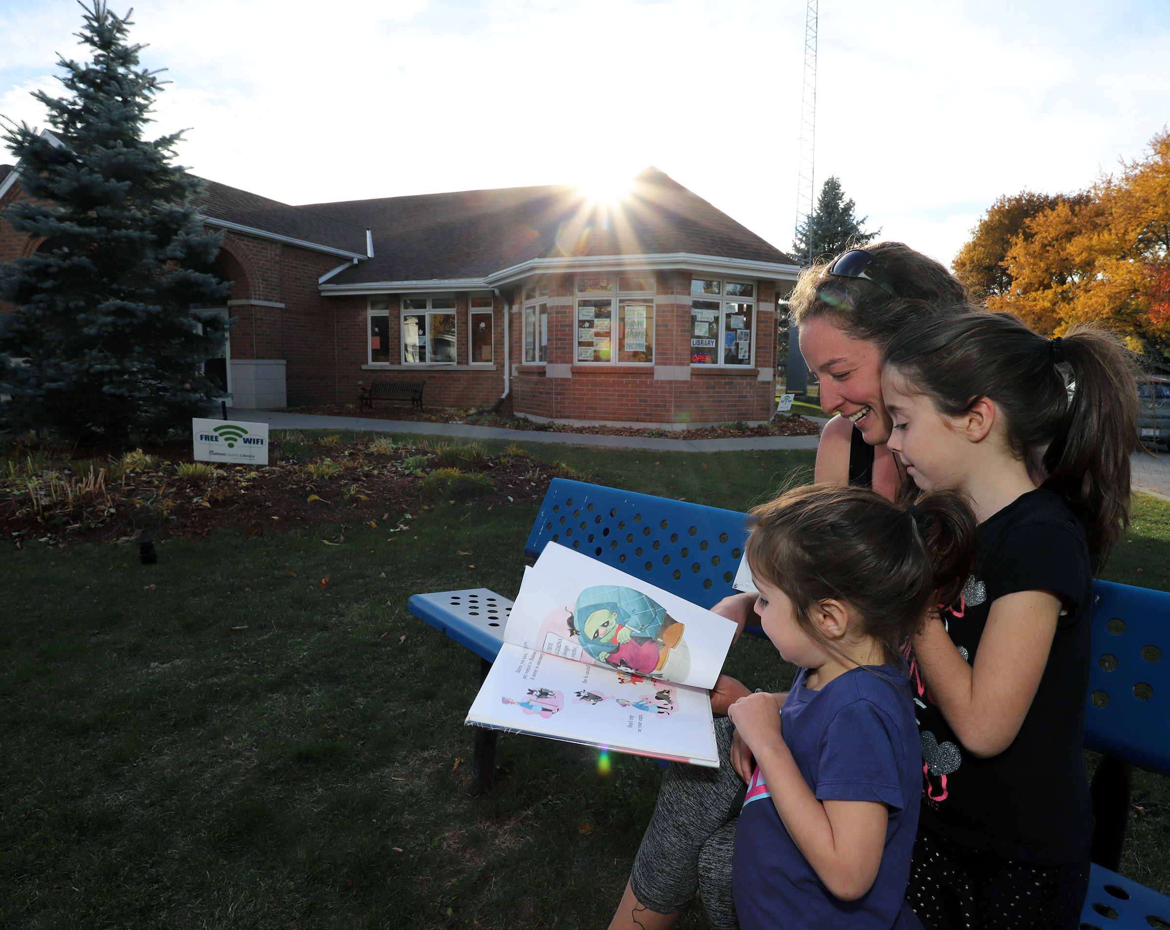 family reading outside Oxford County Library branch