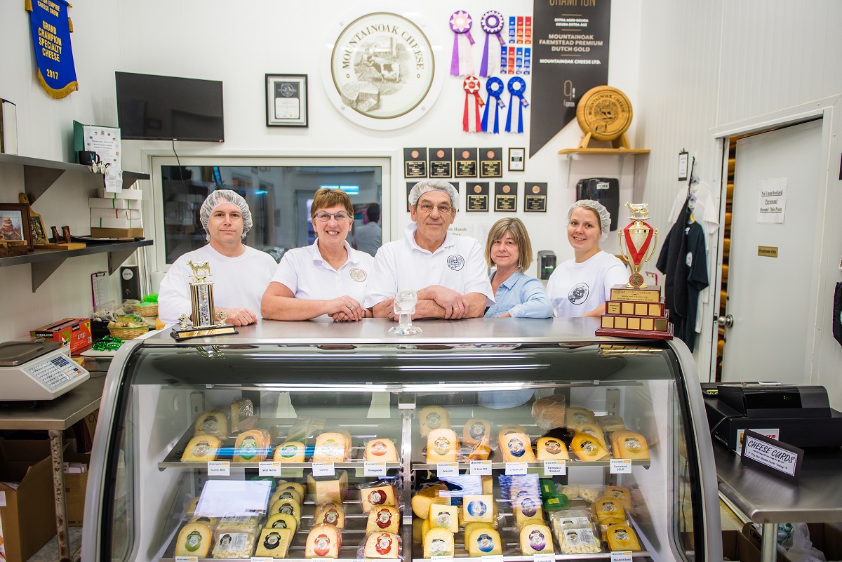 Mountainoak team in the farm store behind the cheese counter with loads of medals, trophies and ribbons from all their awards. It is seriously impressive.