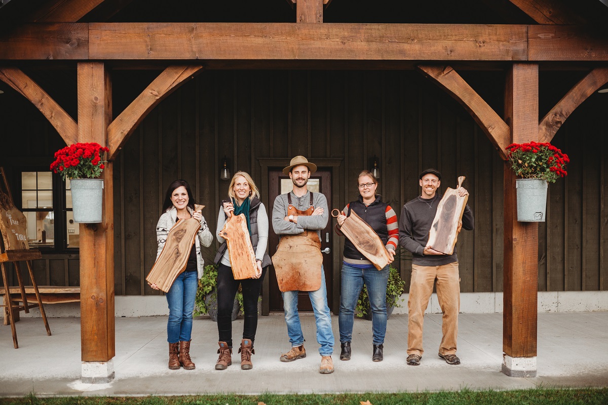 group holding charcuterie boards in tree to table gift experience