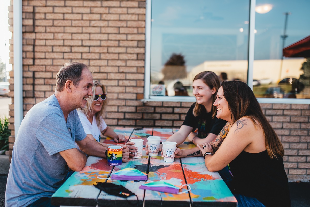 four people having coffee at Early Bird Coffee