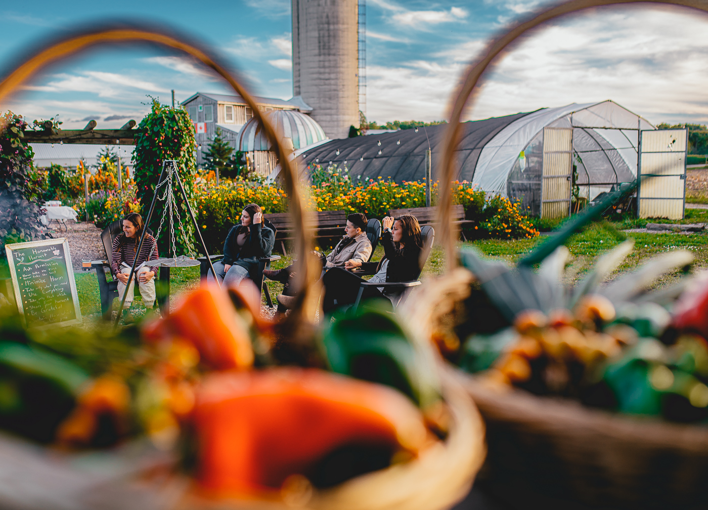 Hopeful Harvest group gathers around fire, nestled in garden