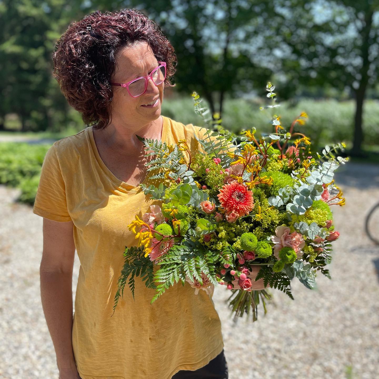 Ieneke from Rombouts Pottery and Flowers holding a bouquet