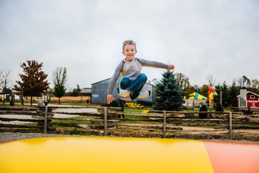 boy jumping on a giant air pillow