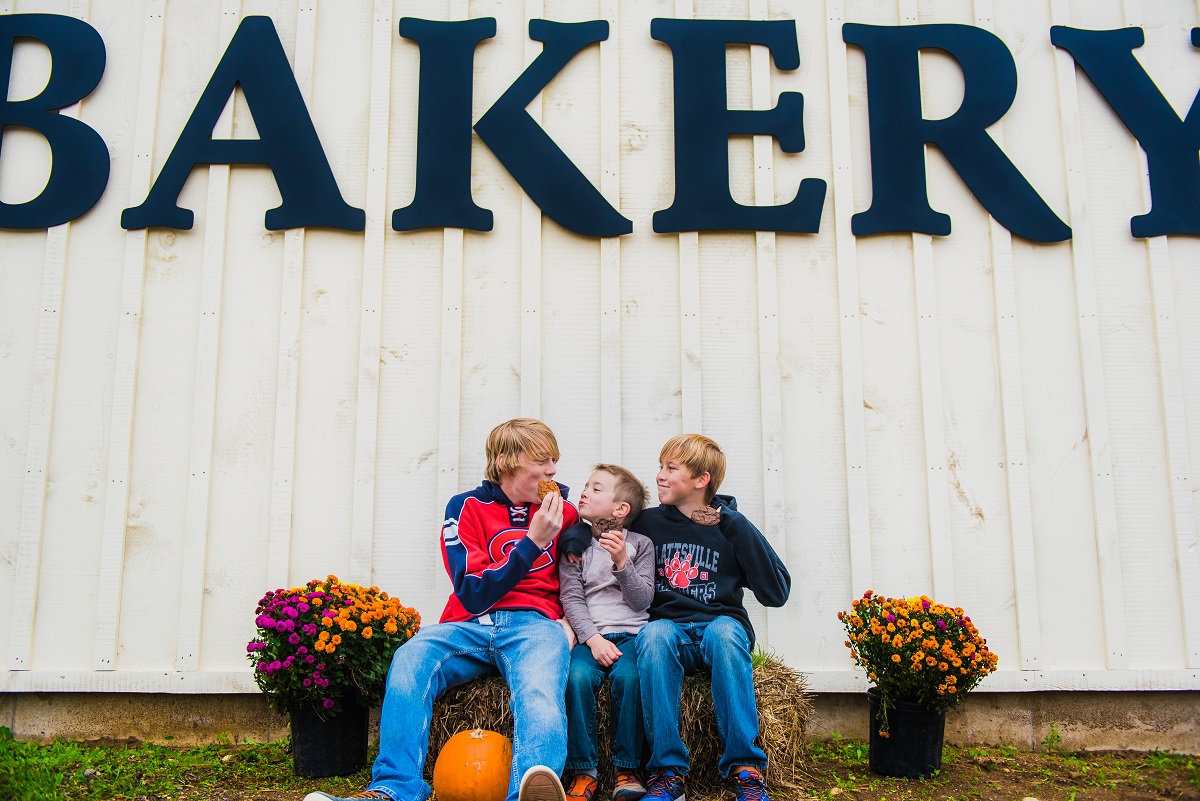 3 boys in front of the bakery