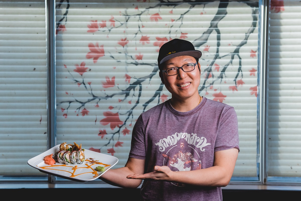 peter at sushi cove holding rolls