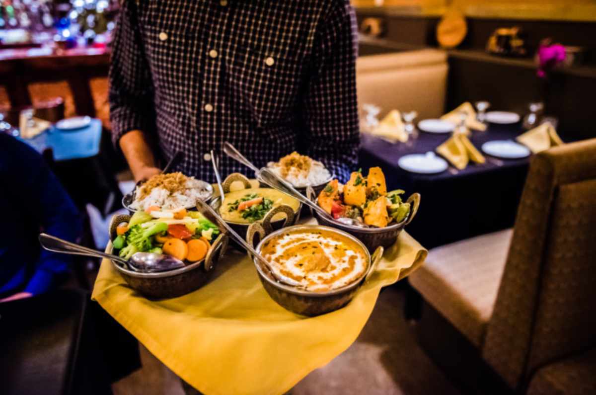 several bowls from tandoori kngiht on a tray