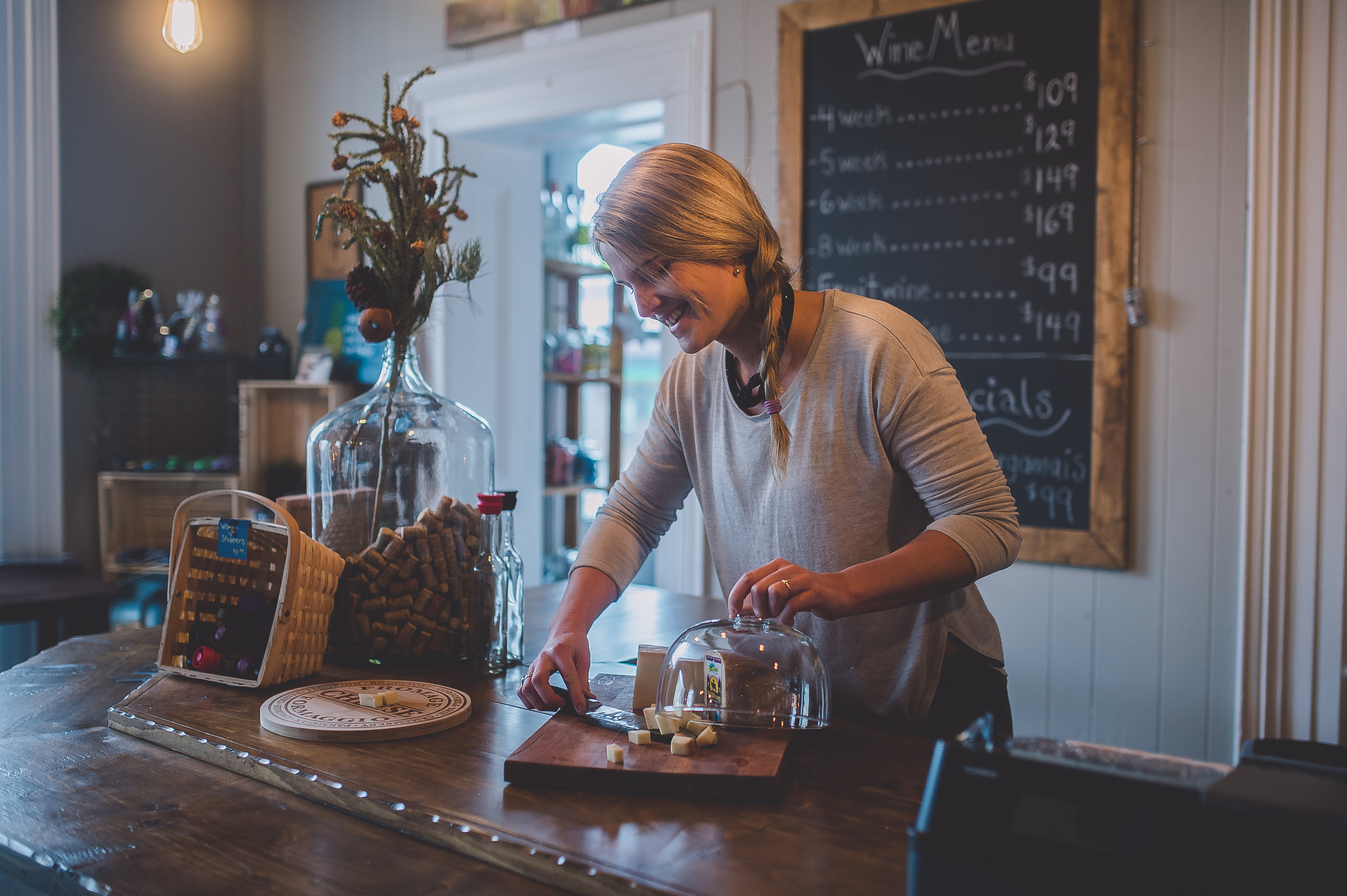 Wine Cellar owner Annalies prepares a cheese plate