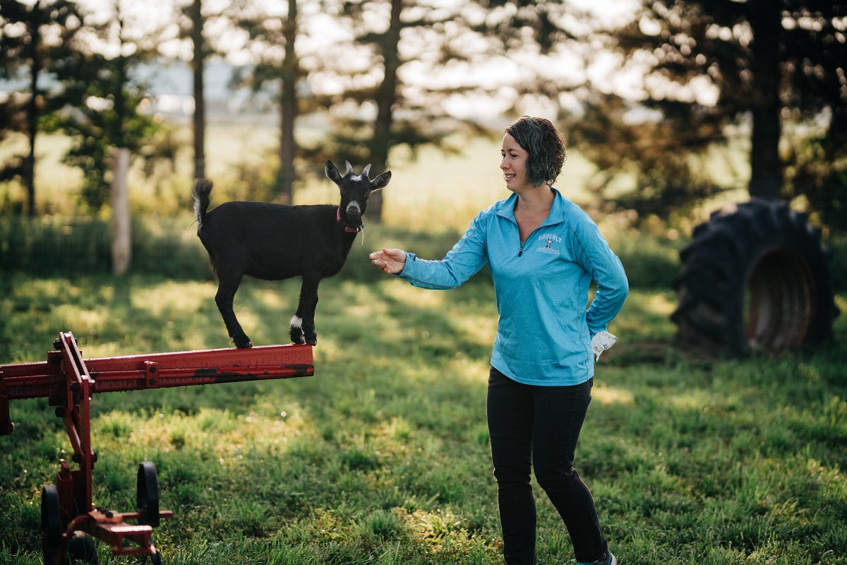 Cheryl playing with a goat at Udderly Ridiculous Farm Life