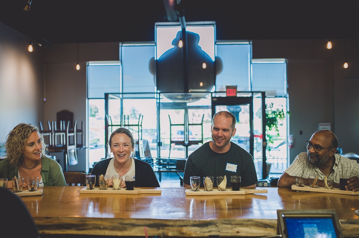 four friends at the bar at upper thames brewing company