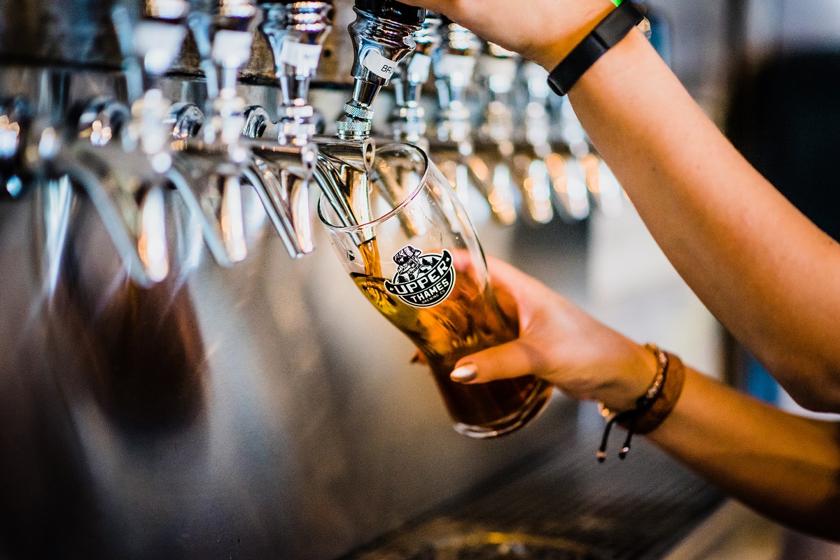 pouring a pint of stout off the tap