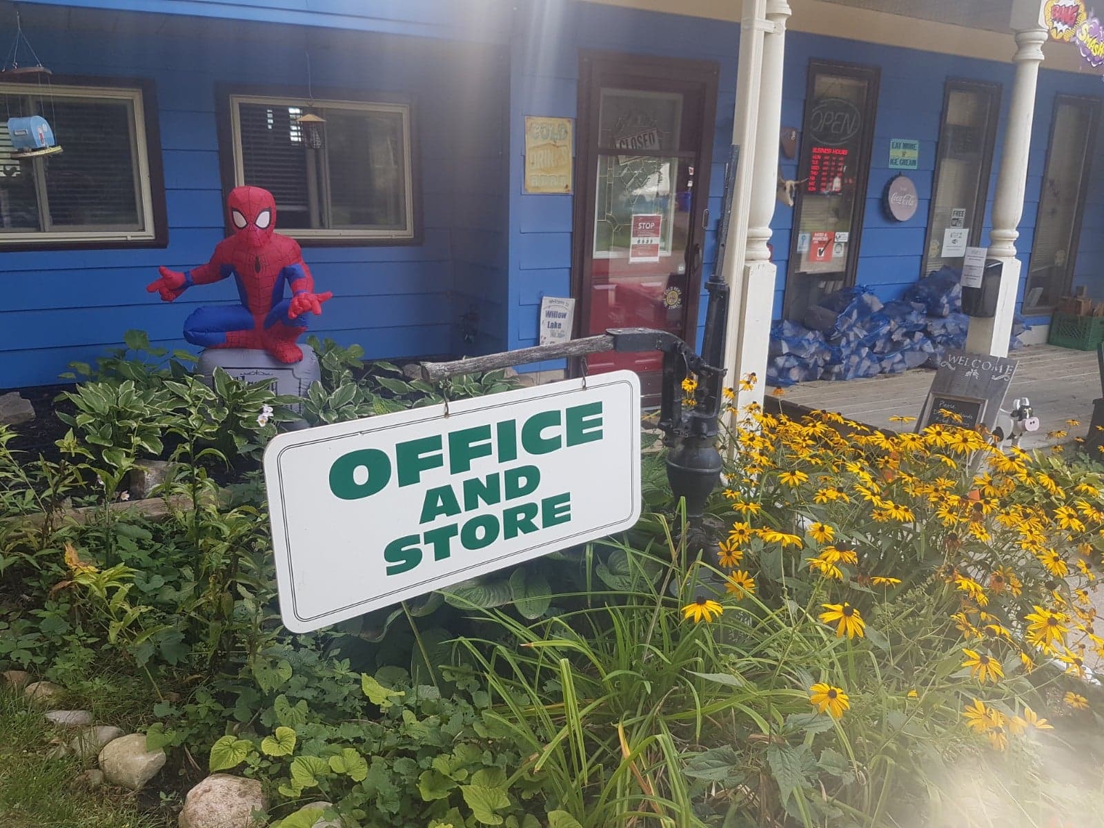 photo of person dressed as spiderman outside of the camp office and store
